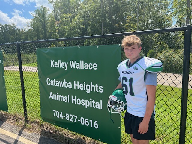 Dr. Wallace's son next to the sponsorship sign